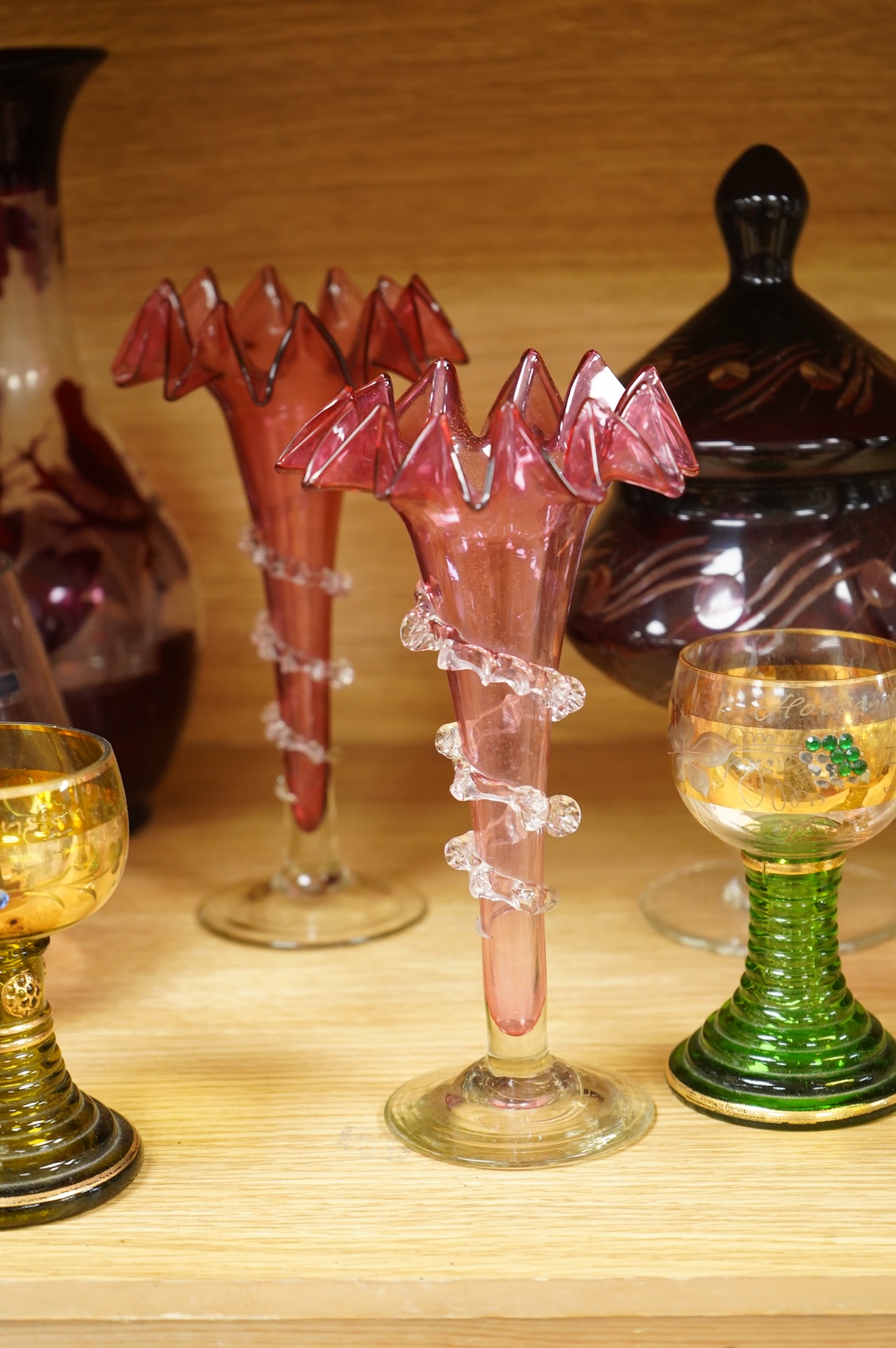 A collection of 19th century and later glassware to include three goblets, a pair of vases with trailed decoration and a Caithness glass vase, largest 28cm high